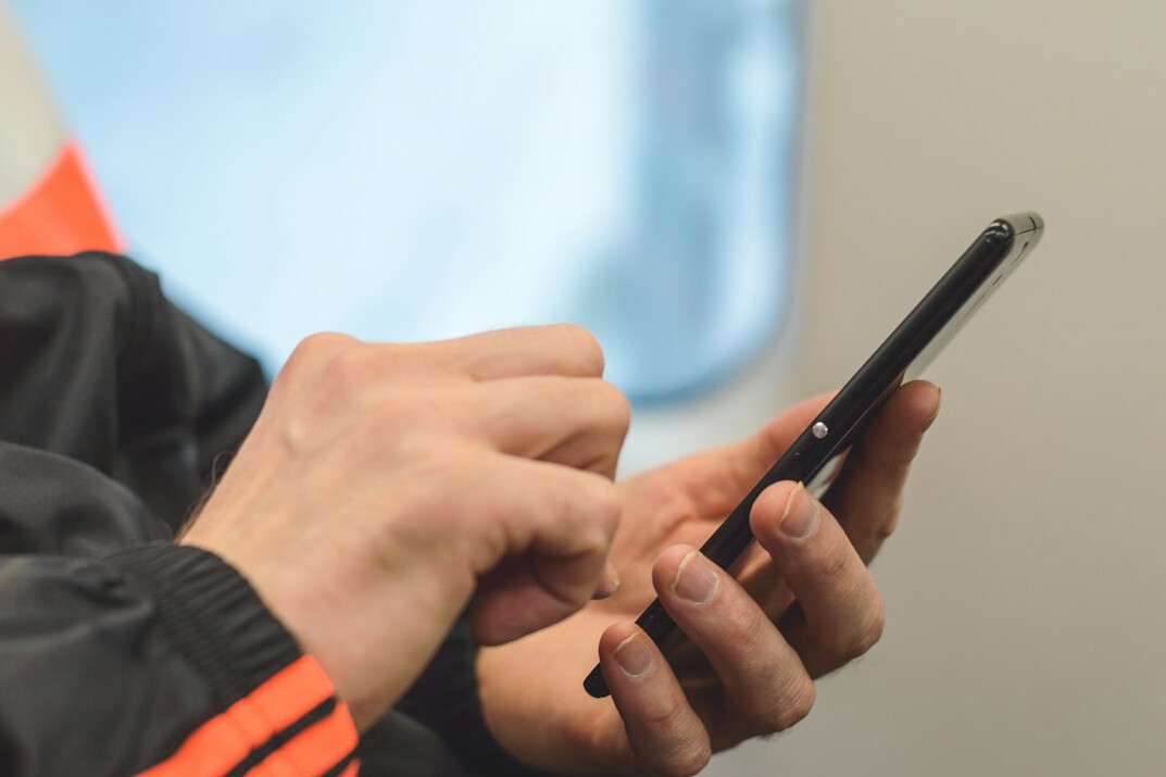person scrolling on smartphone
